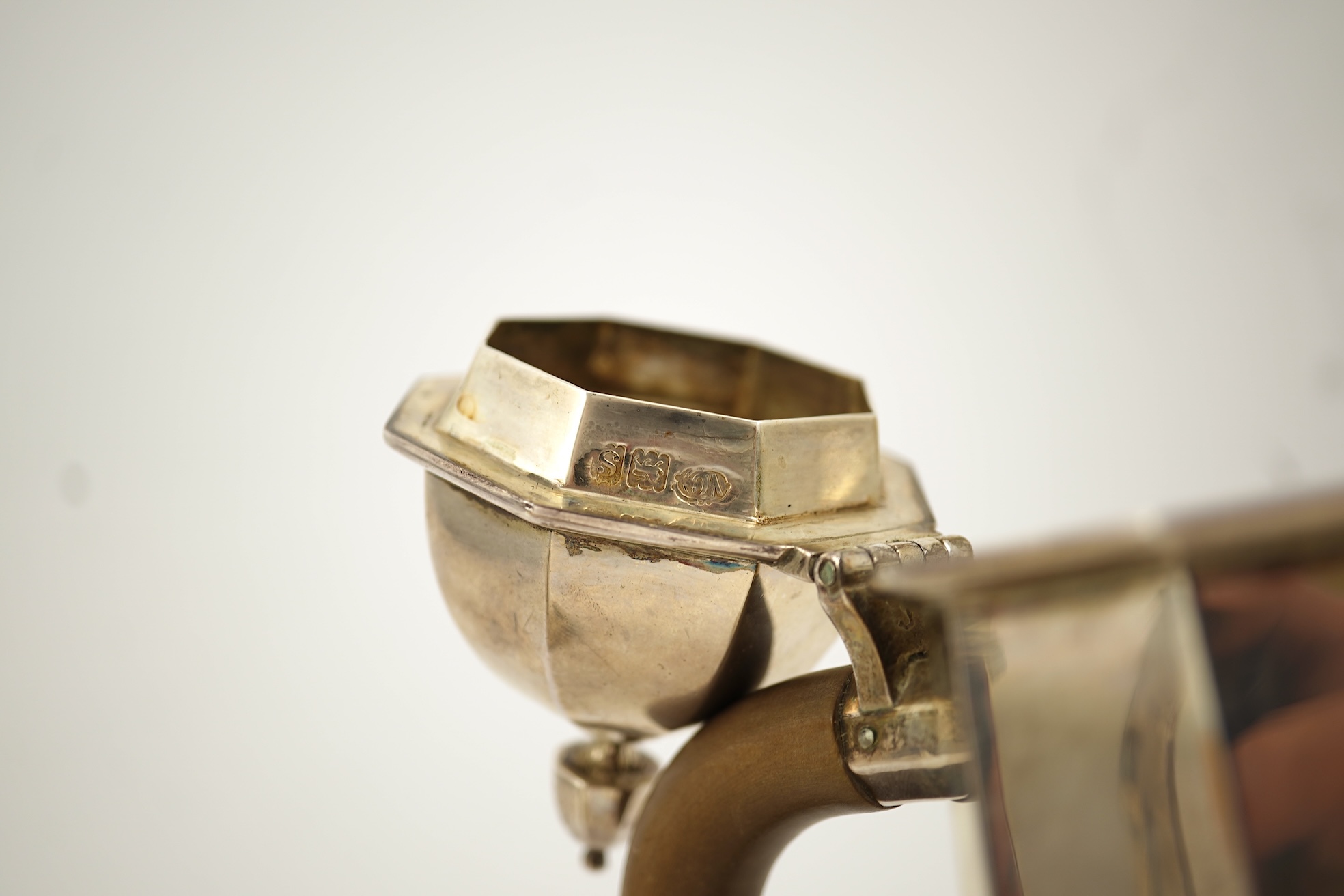 A pair of George V octagonal silver café au lait pots, by William Comyns & Sons Ltd